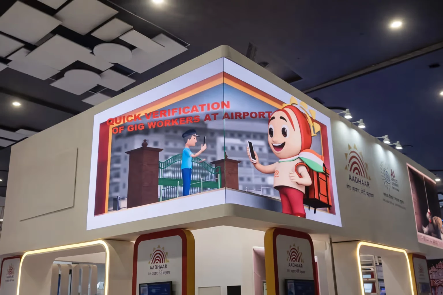 Smart digital display at an exhibition corner promoting quick verification of gig workers at airports with graphics of a person and a