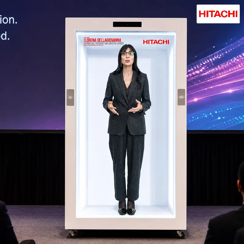 Lorena Dellagiovanna, Senior Vice President and Executive Officer at Hitachi, Ltd., appearing as a live full-height hologram on a
