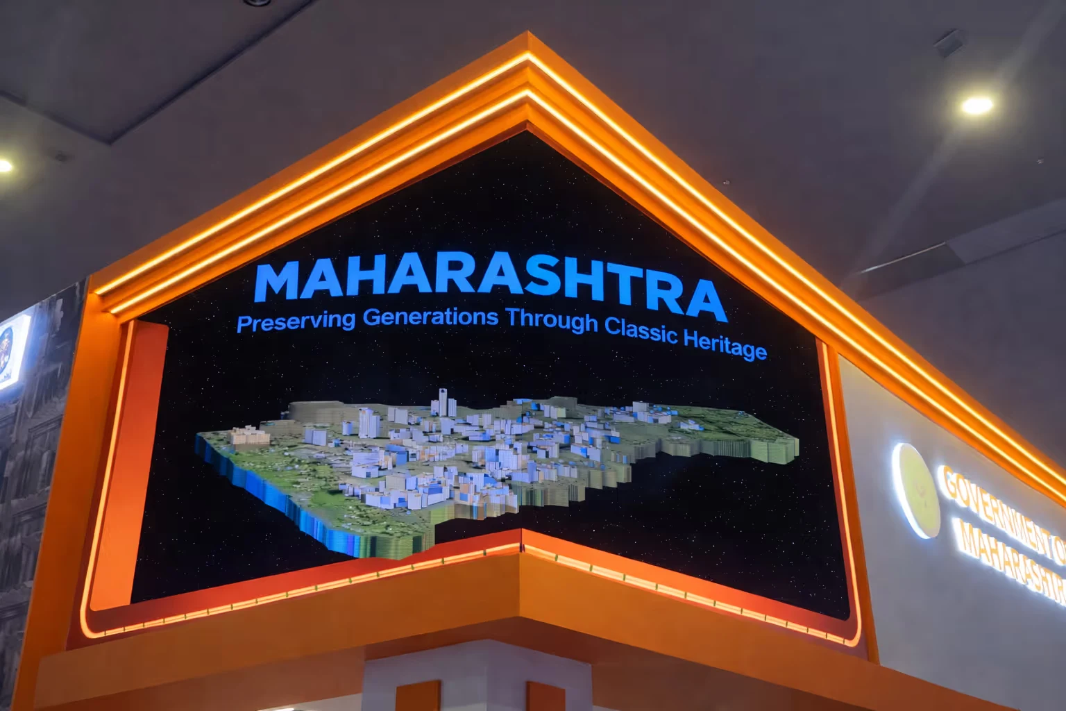 3D model map of Maharashtra state with the text 'MAHARASHTRA Preserving Generations Through Classic Heritage' displayed on a large screen