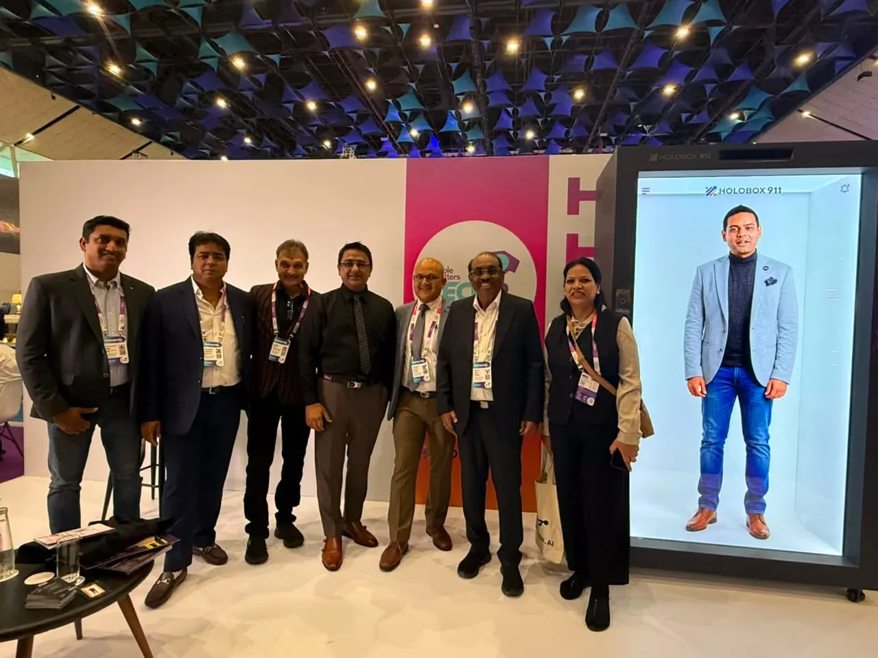 An AI avatar of People Matters CEO Pushkaraj Bidwai on the HoloBox911 display, with delegates at the stand, TechHR India 2026