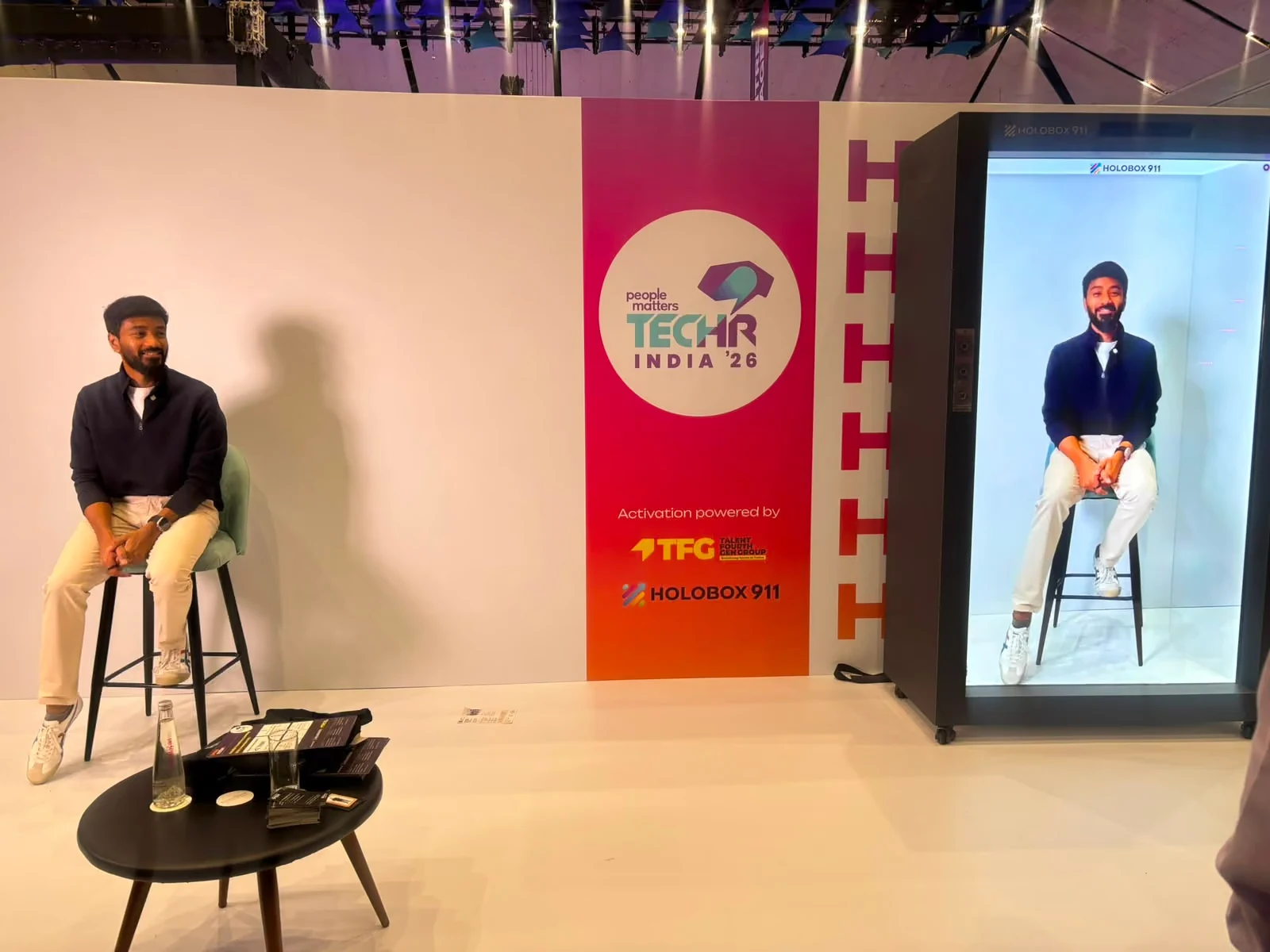 The HoloBox911 stand at TechHR India 2026, with GrowthSchool founder Vaibhav Sisinty appearing live and life-size on the display